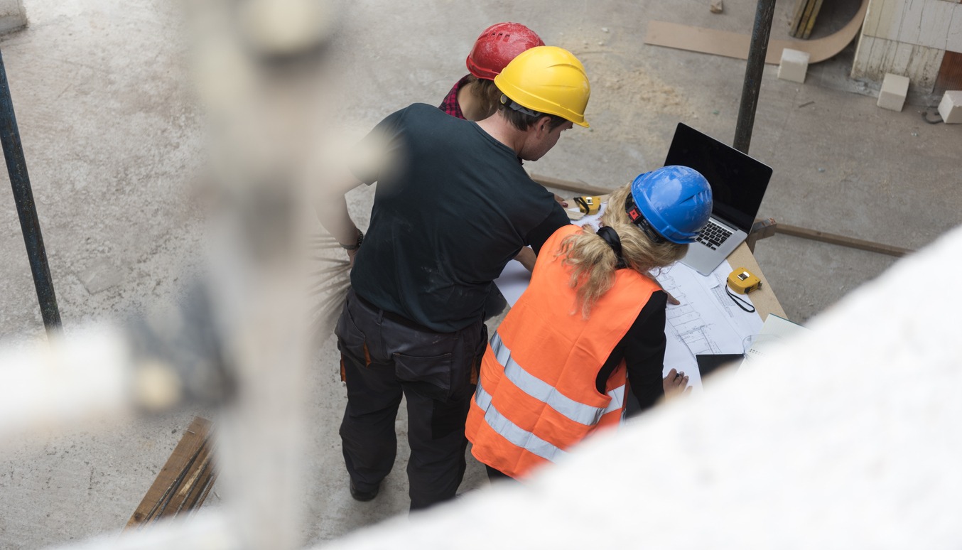 Group of construction workers reviewing plans