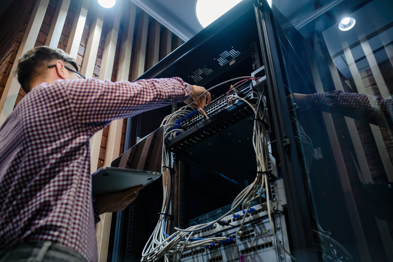 Photo with relfections in the server room a technician/ It engineer/